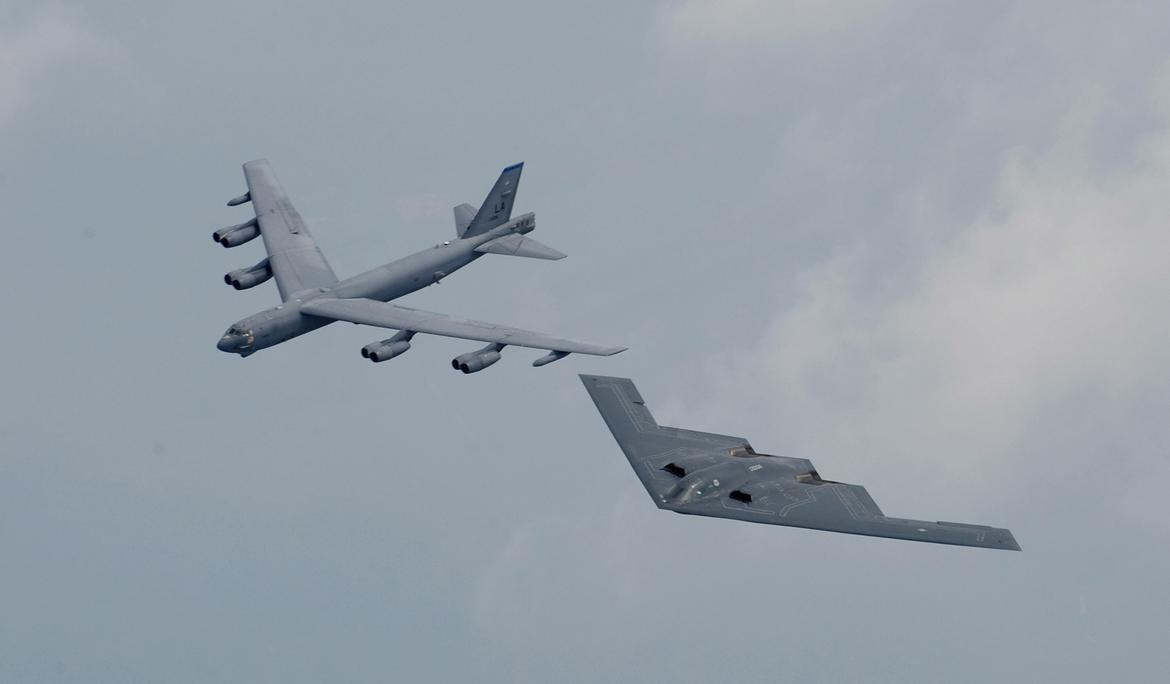 A B-2 Spirit and B-52 Stratofortress fly in formation over Shreveport, La., during the open house and air show at Barksdale Air Force Base.